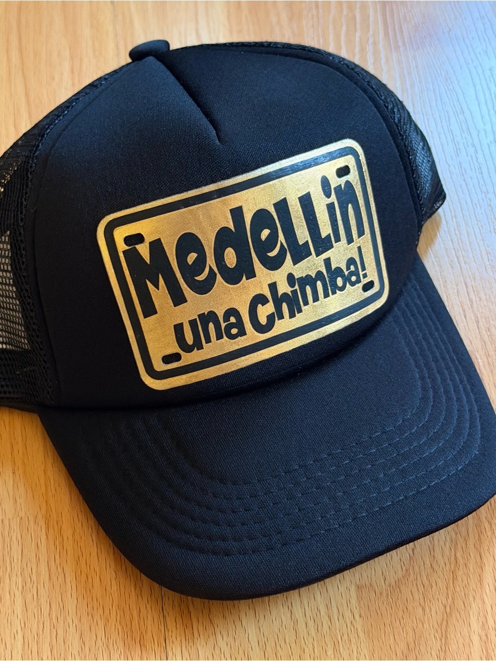 Medellín Una Chimba! Black Trucker Cap with Gold Print.